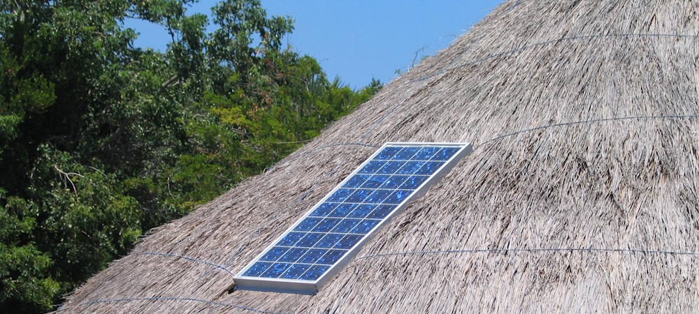 Solar panels low cost housing - Solar Panel on native thatch house roof