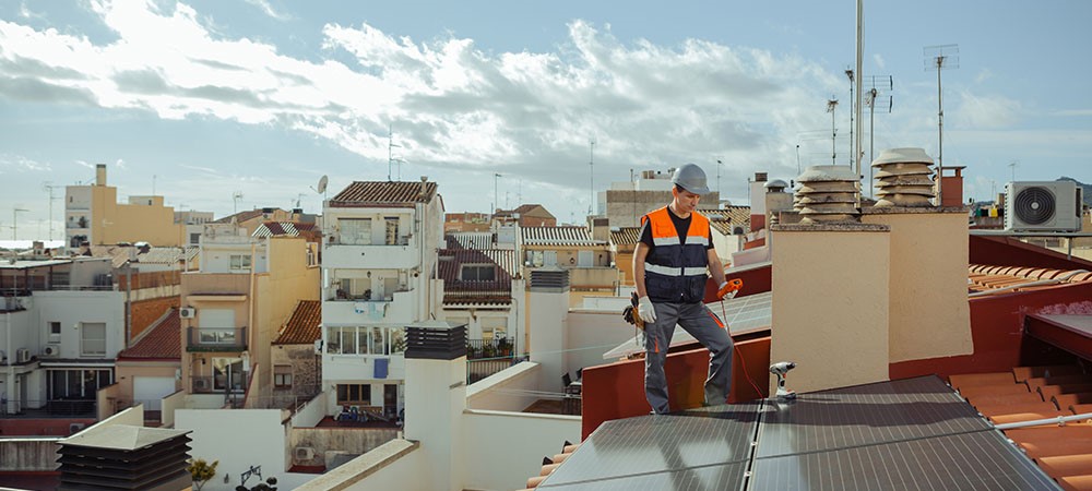 Man on roof Installing Solar Panels