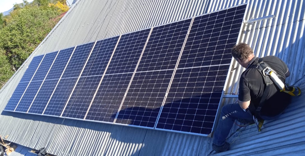 Solar Installers Western Cape - Solar Technician On Roof Installing Solar Panels